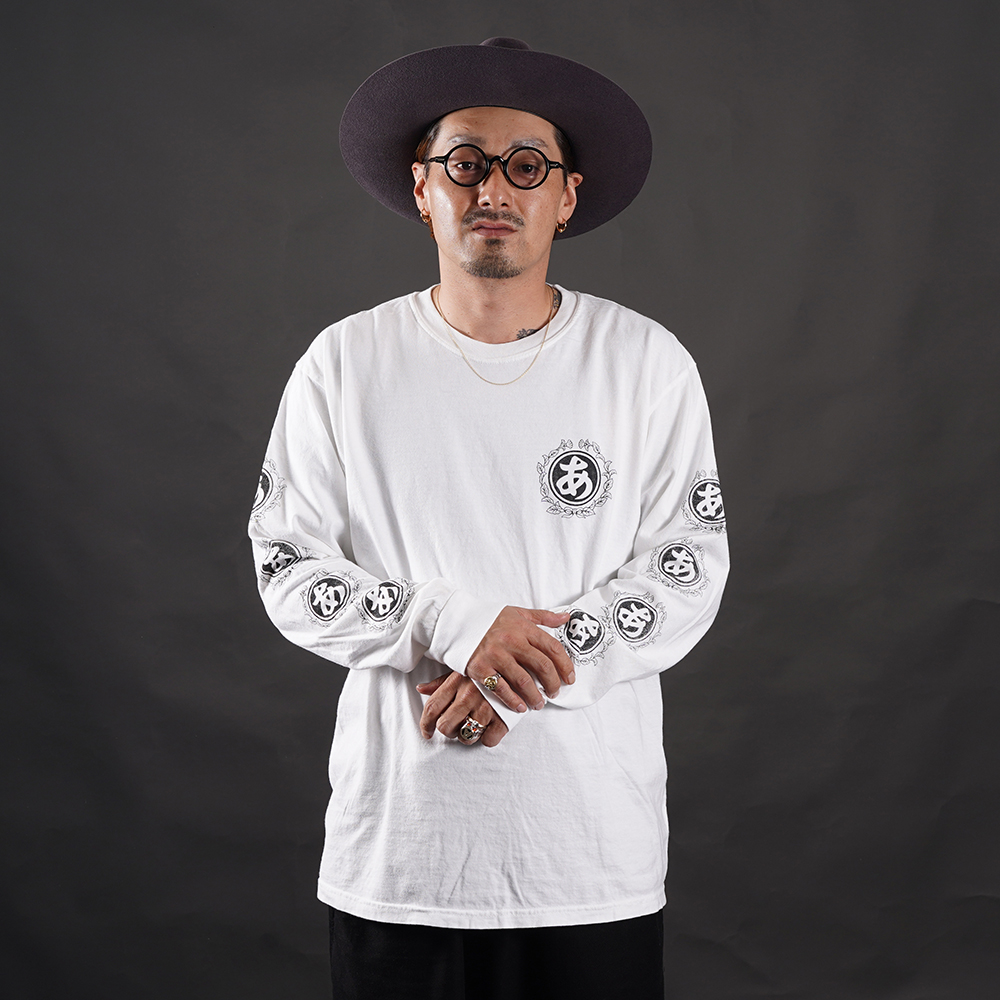 THE AMERICAN WANNABE/アメリカンワナビー「TRADE MARK ARCHIVE L/S TEE / WHITE」スリーブプリント長袖Tシャツ