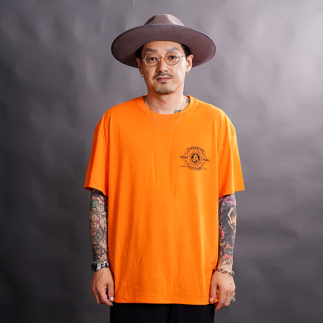 AWTO-260101 /「TRADE MARK S/S TEE / ORANGE」プリントS/S Tシャツ