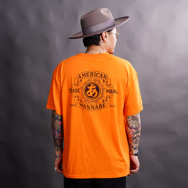 AWTO-260101 /「TRADE MARK S/S TEE / ORANGE」プリントS/S Tシャツ