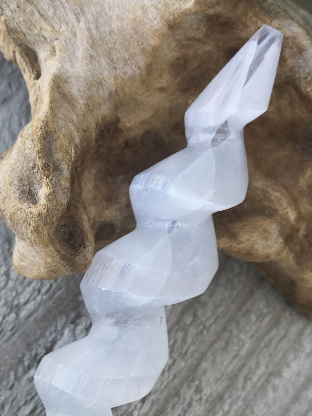 D）透明感のある光を放つ『セレナイト・スパイラルワンド』 D）透明感