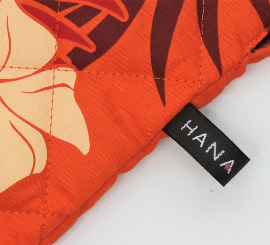 オレンジ地に、白、クリ－ム色のプルメリア模様と茶、赤の葉模様がおしゃれな、カラアウケース