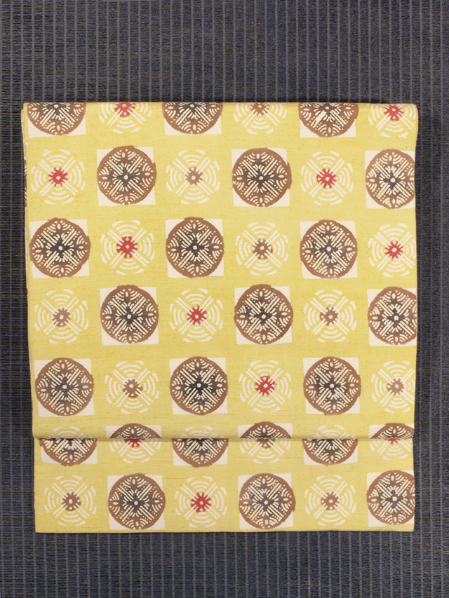 丸に幾何学文様 型染め 紬 名古屋帯