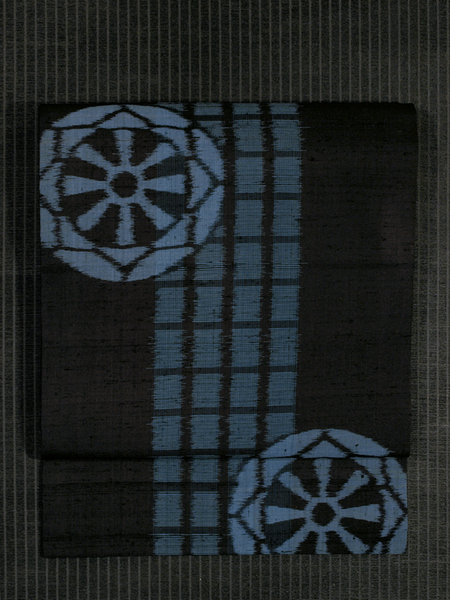 格子縞に源氏車文様 絣織り 名古屋帯