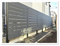 �׉ƂƂ̋��E�����ɐݒu�����l�H�ؖډB���t�F���X�i�u���b�N�F�j