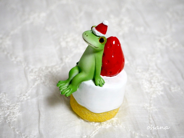 クリスマスケーキに座るカエル