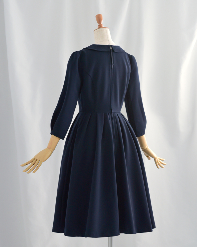 ネイビーワンピースの後ろ姿、バックファスナー仕様で着脱しやすい上品ワンピース