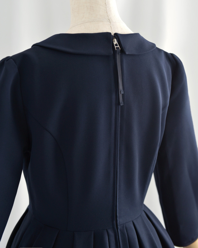 後ろファスナー仕様のネイビーワンピース、着脱がしやすくシルエットも美しい仕上がり